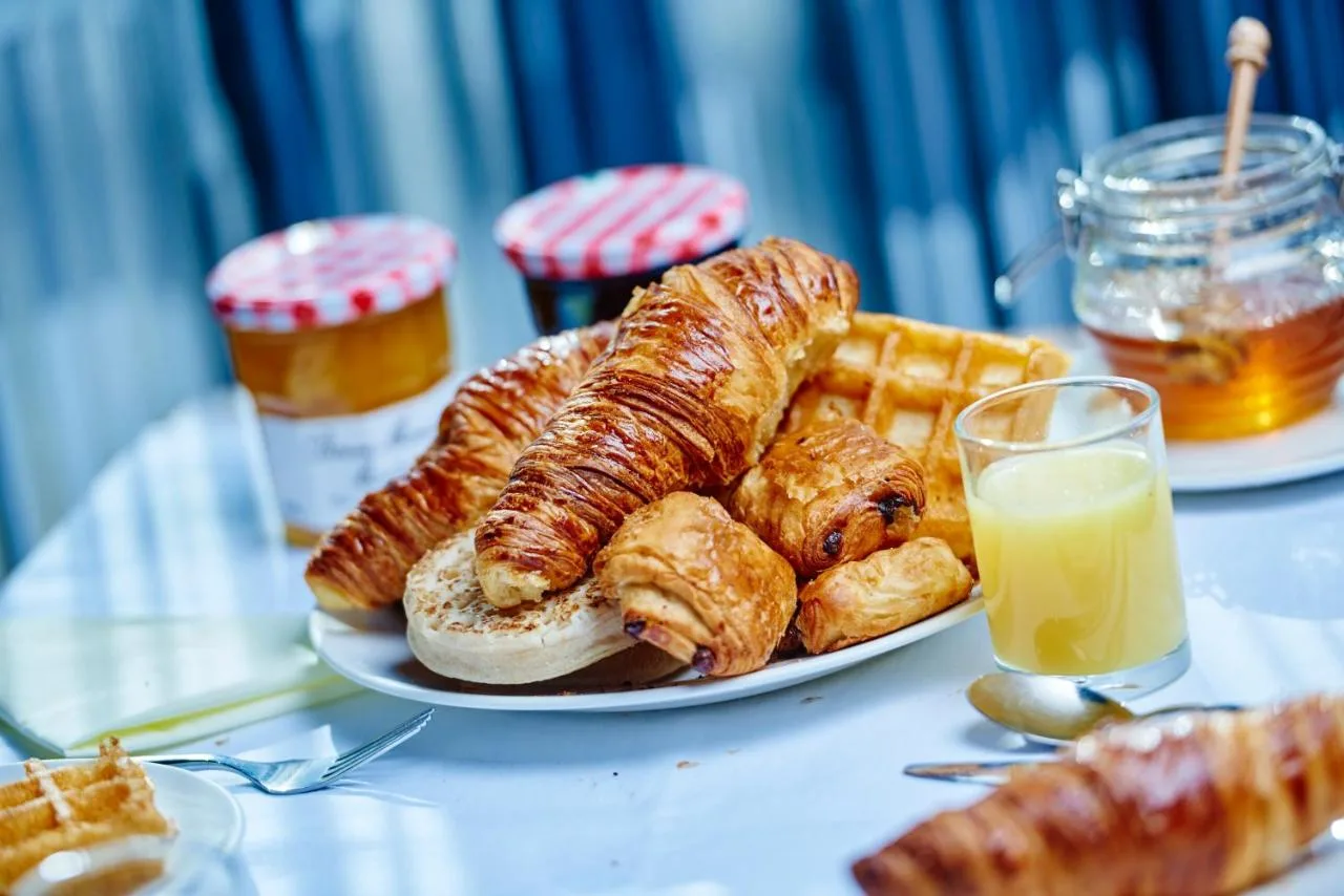 Table with pastries, bread and orange juice at Leonardo Royal Hotel Edinburgh